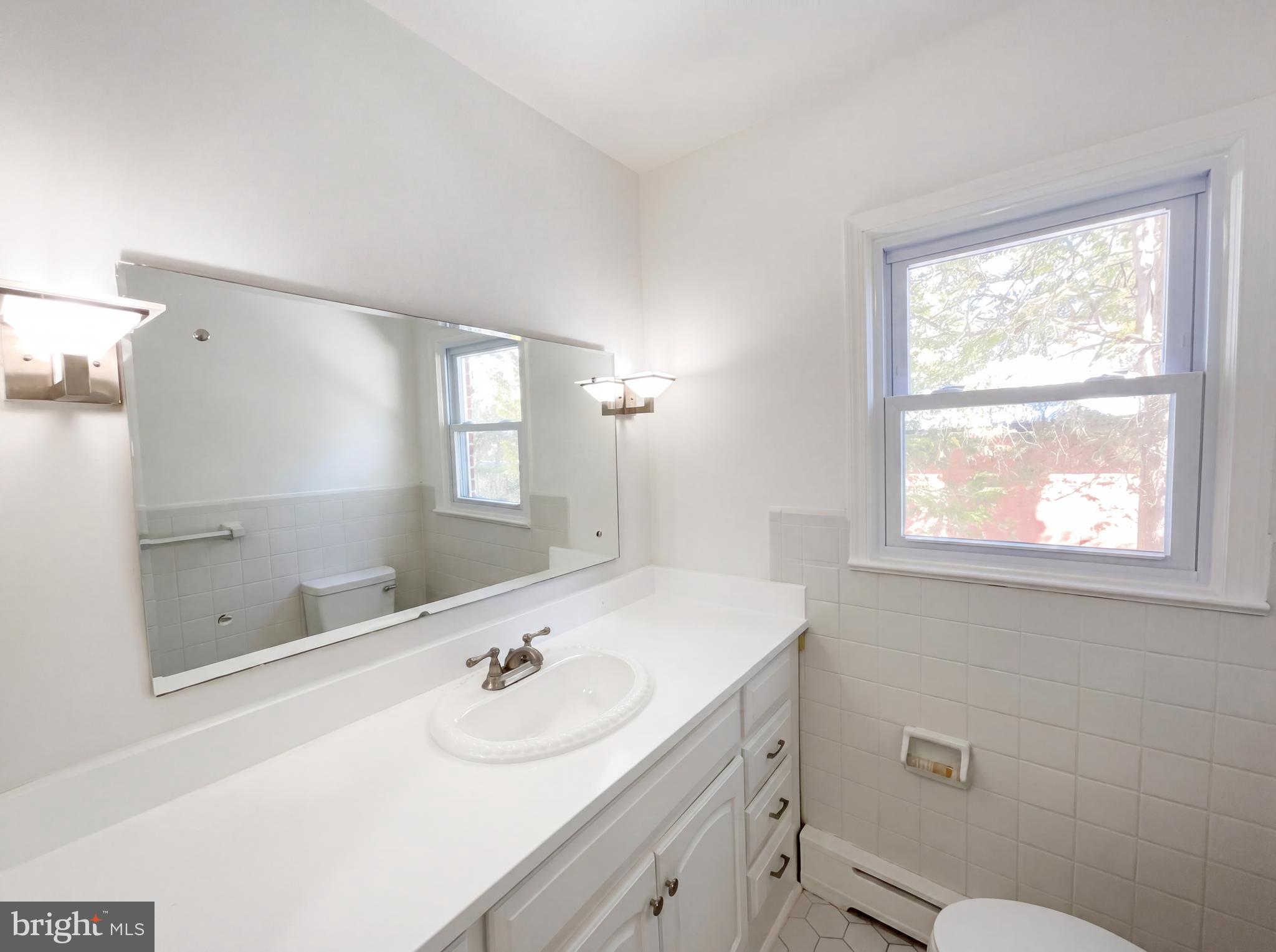 6048 Old Telegraph Road Alexandria, VA 22310 - Photo 16 of 43 a bathroom with a sink a toilet and shower