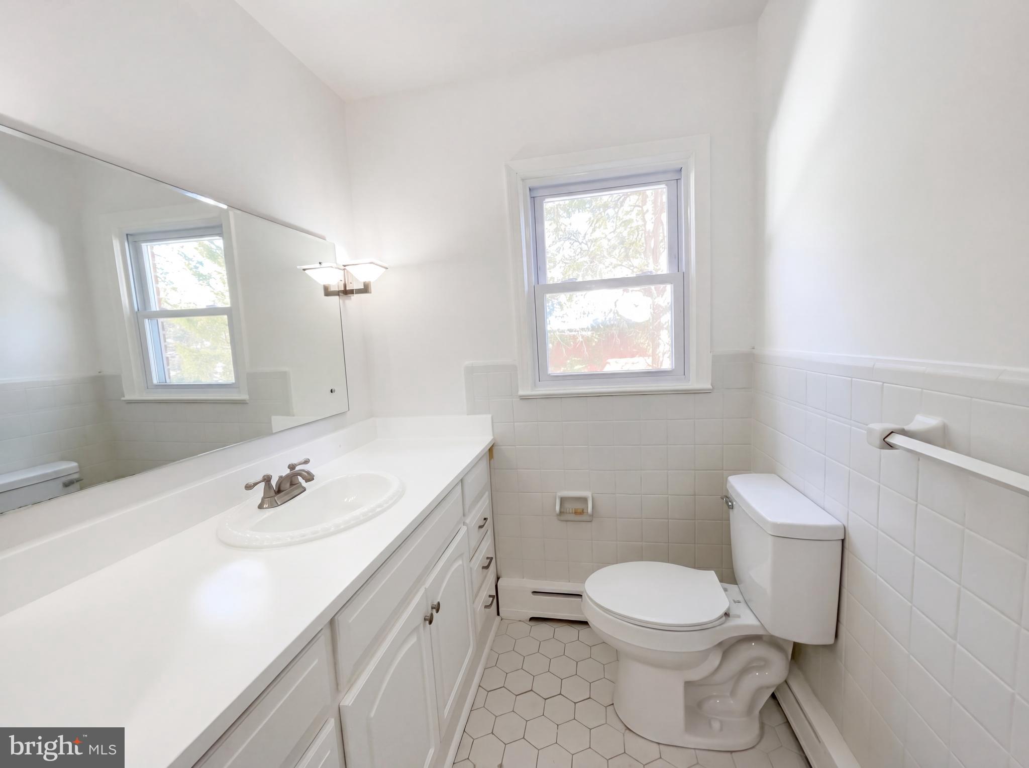 6048 Old Telegraph Road Alexandria, VA 22310 - Photo 17 of 43 a bathroom with a sink a toilet and window