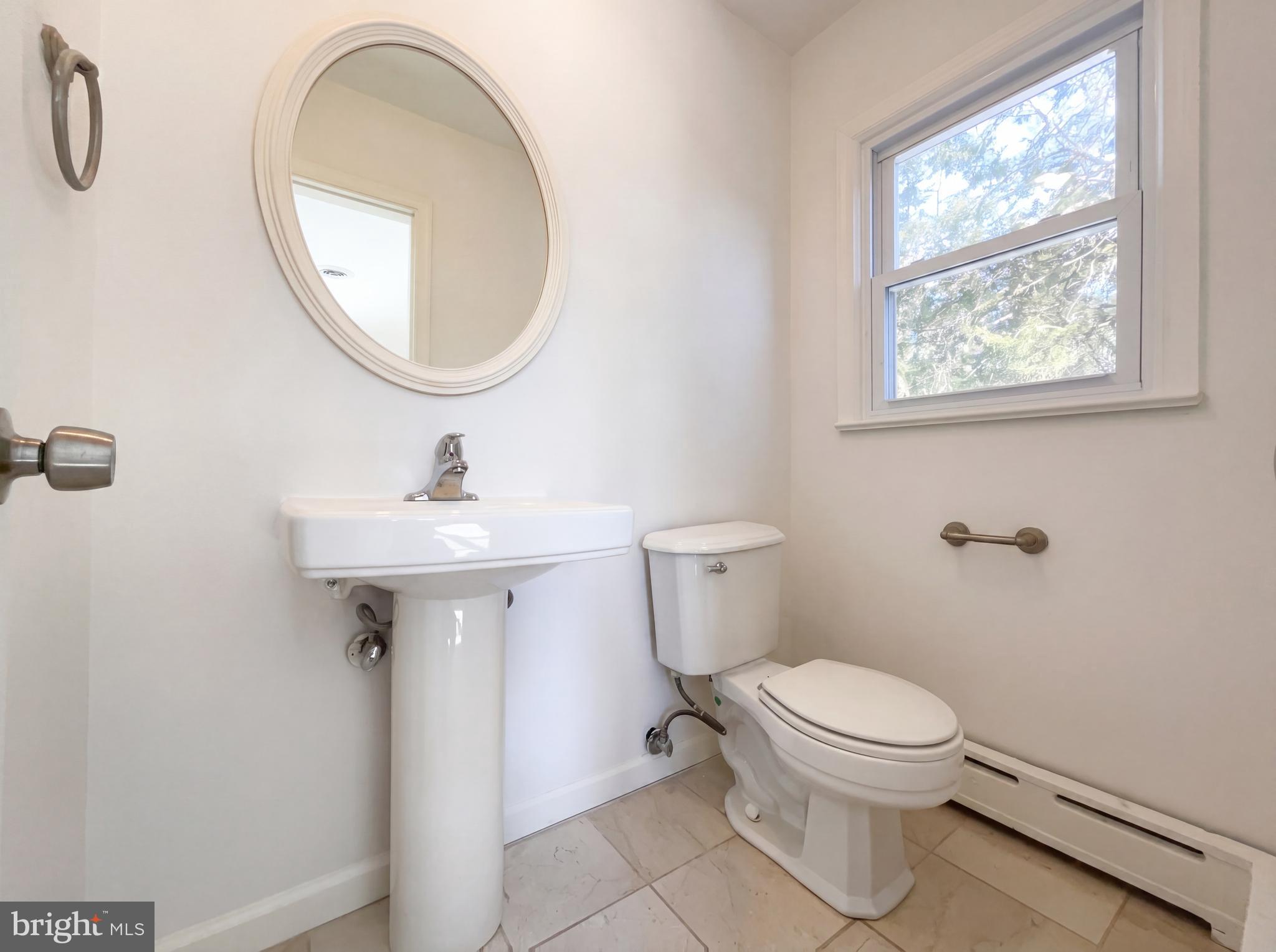 6048 Old Telegraph Road Alexandria, VA 22310 - Photo 19 of 43 a white toilet sitting next to a bathroom sink