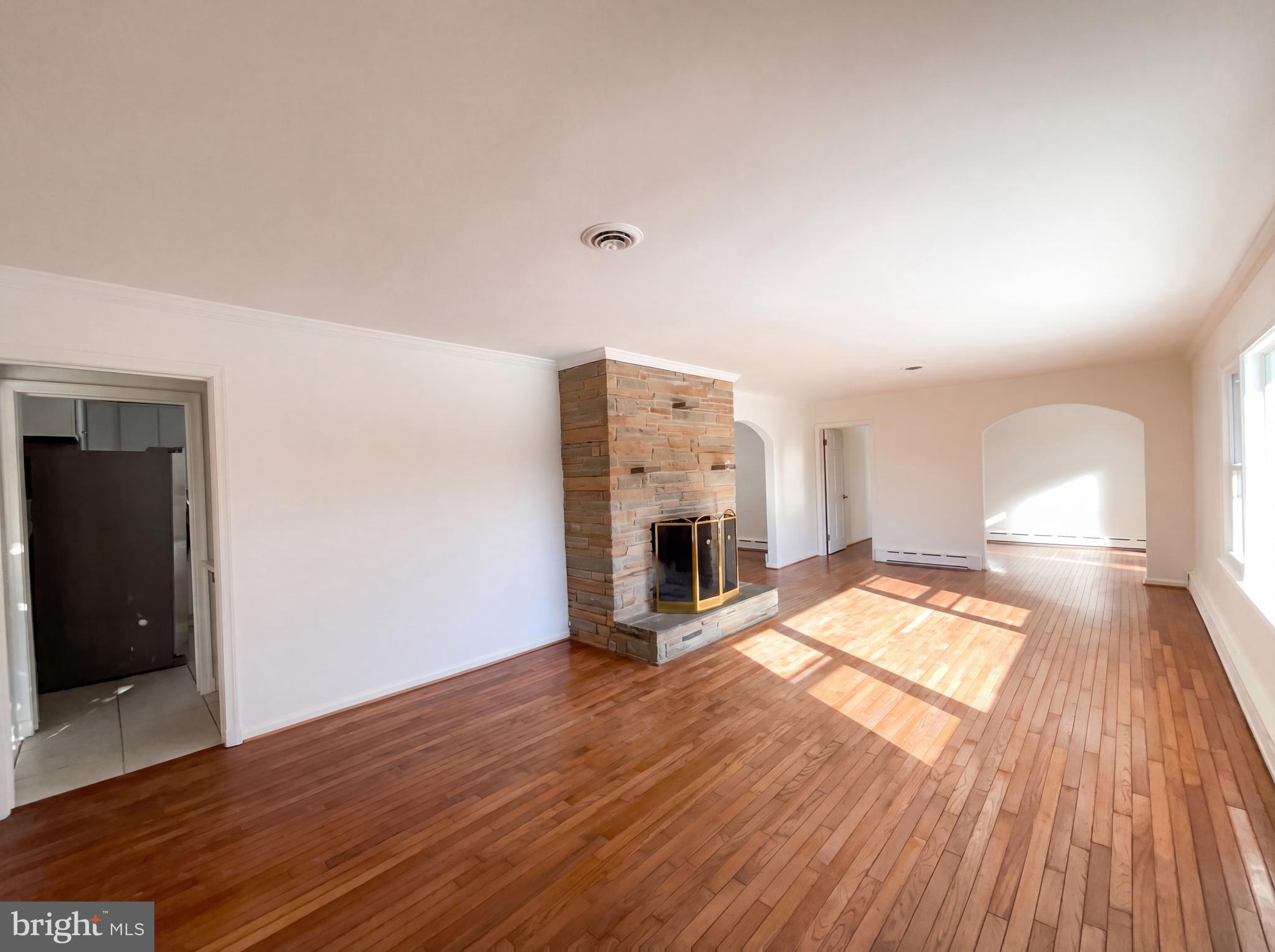 6048 Old Telegraph Road Alexandria, VA 22310 - Photo 10 of 43 a view of empty room with wooden floor and fireplace