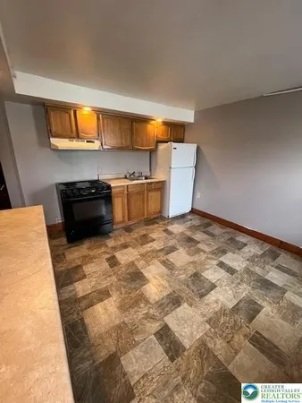 a kitchen with a stove a sink and a refrigerator