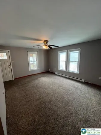 a view of an empty room with windows