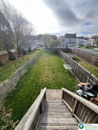 a view of a river and yard with seating area