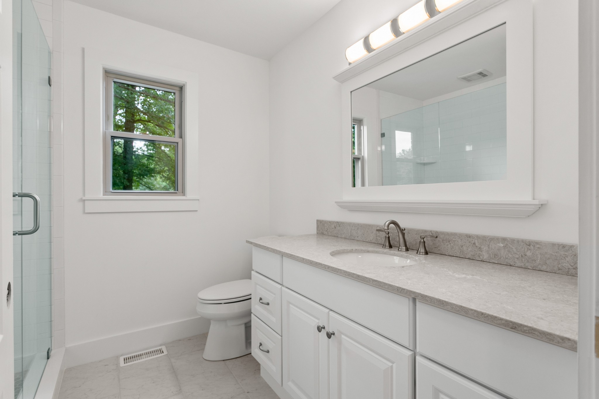 2338 North Road Murfreesboro, TN 37128 - Photo 26 of 48 a bathroom with a granite countertop toilet a sink a mirror and a window