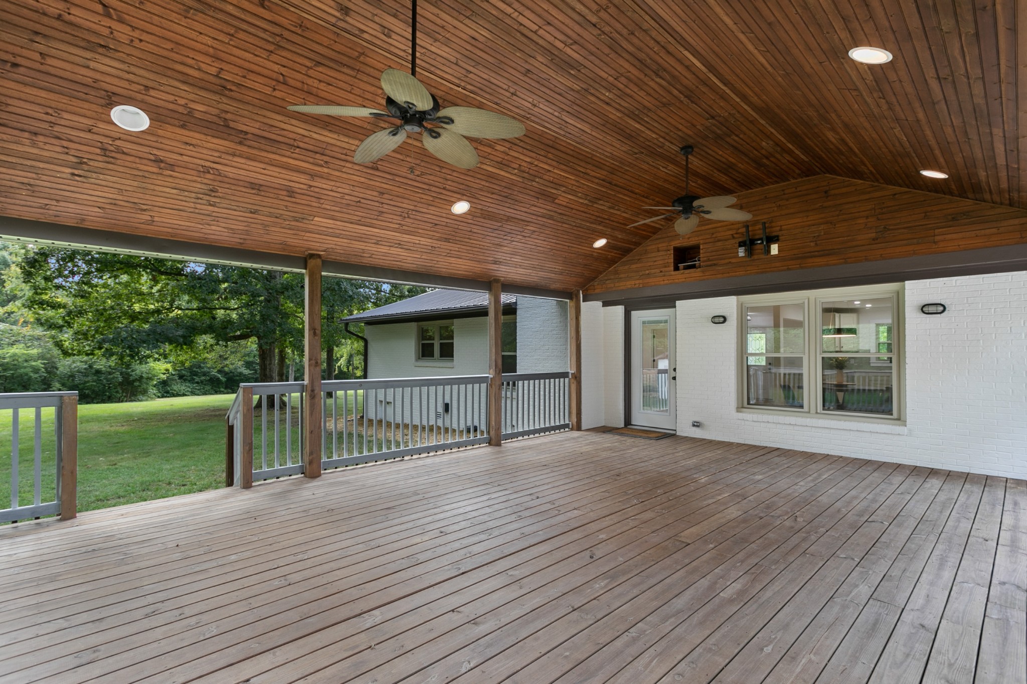 2338 North Road Murfreesboro, TN 37128 - Photo 40 of 48 an empty room with wooden floor a ceiling fan and windows