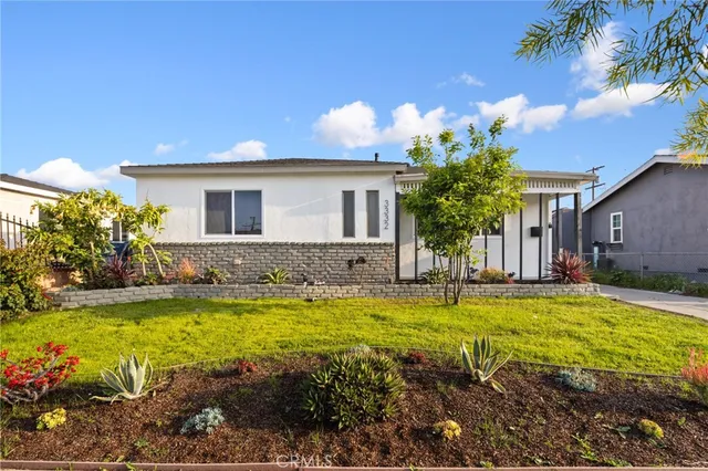 a view of a house with swimming pool and a yard