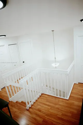 a view of a room with wooden floor