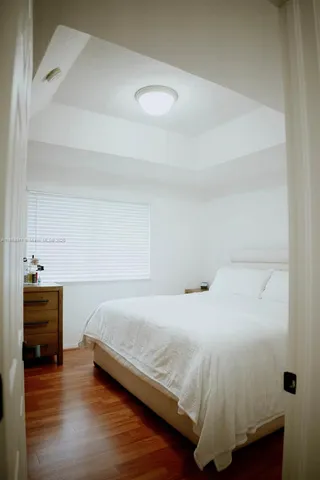 a bedroom with a bed and flat screen tv