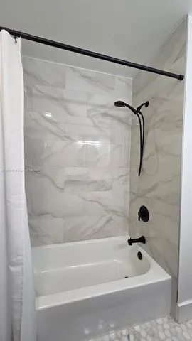 a reading room with wooden floor and furniture