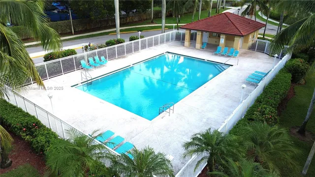 an aerial view of a house with a yard and trees