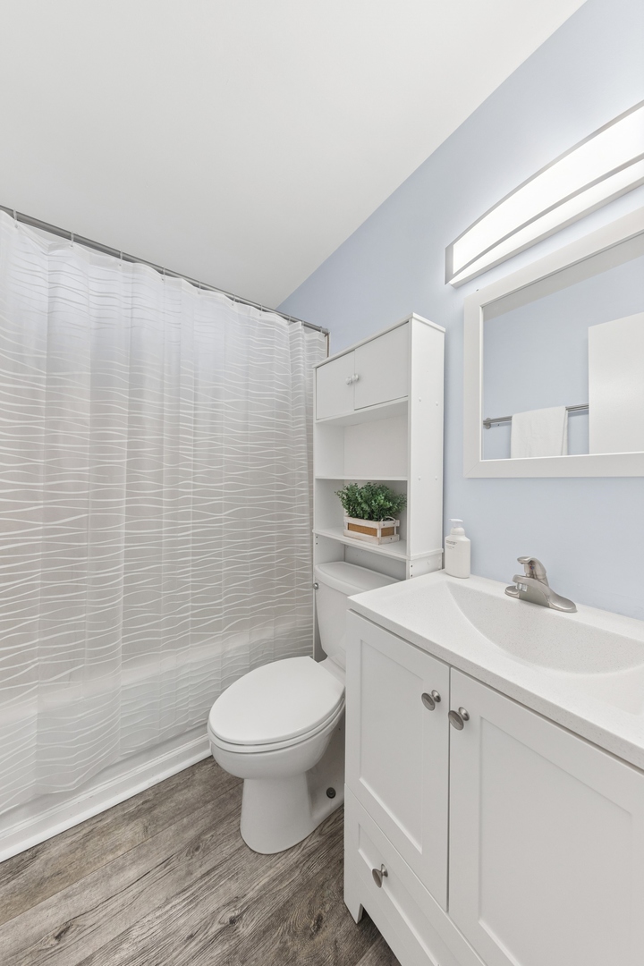 335 Macon Avenue Romeoville, IL 60446 - Photo 14 of 19 a bathroom with a sink a toilet and shower