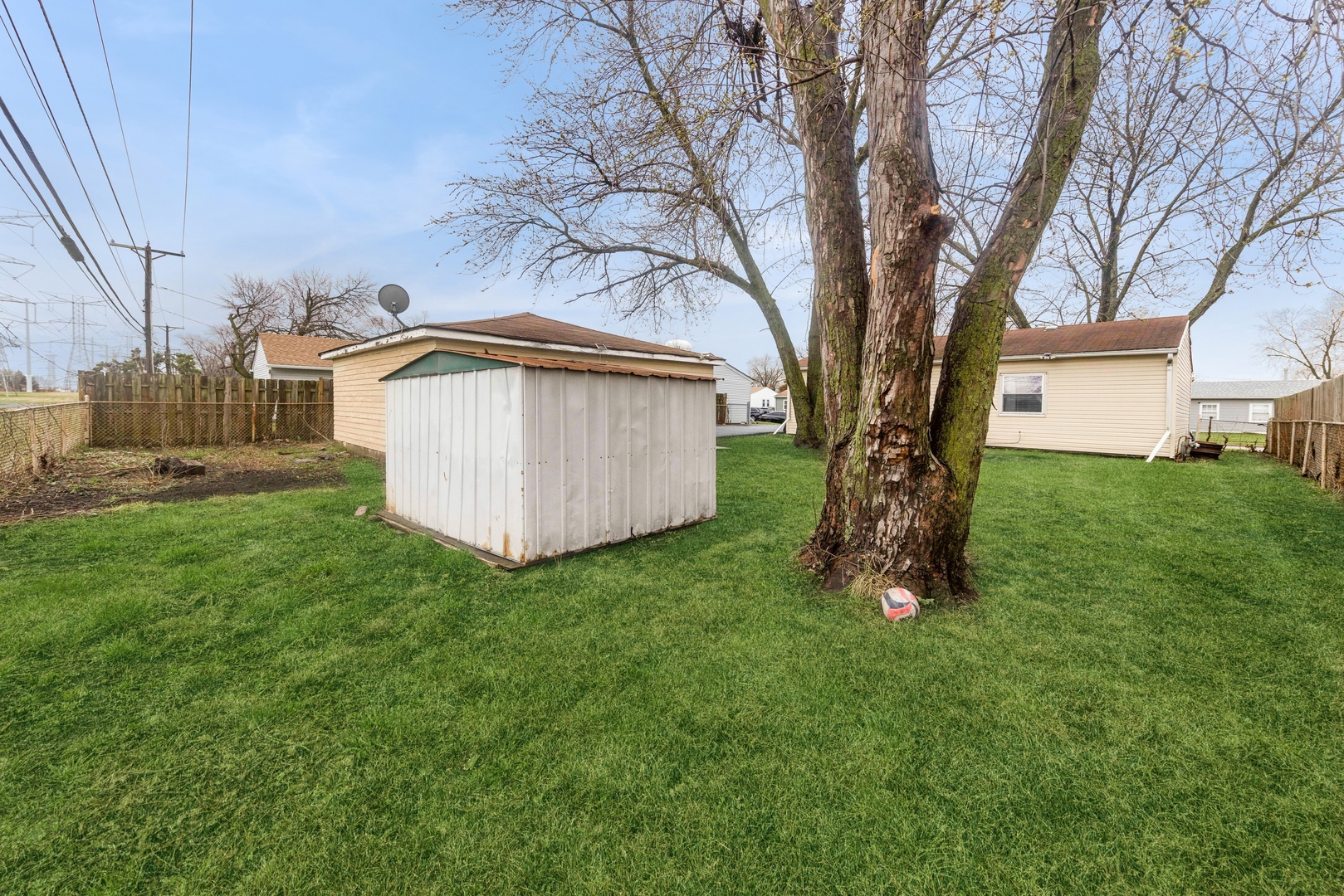 335 Macon Avenue Romeoville, IL 60446 - Photo 18 of 19 a view of backyard with a house and a large tree