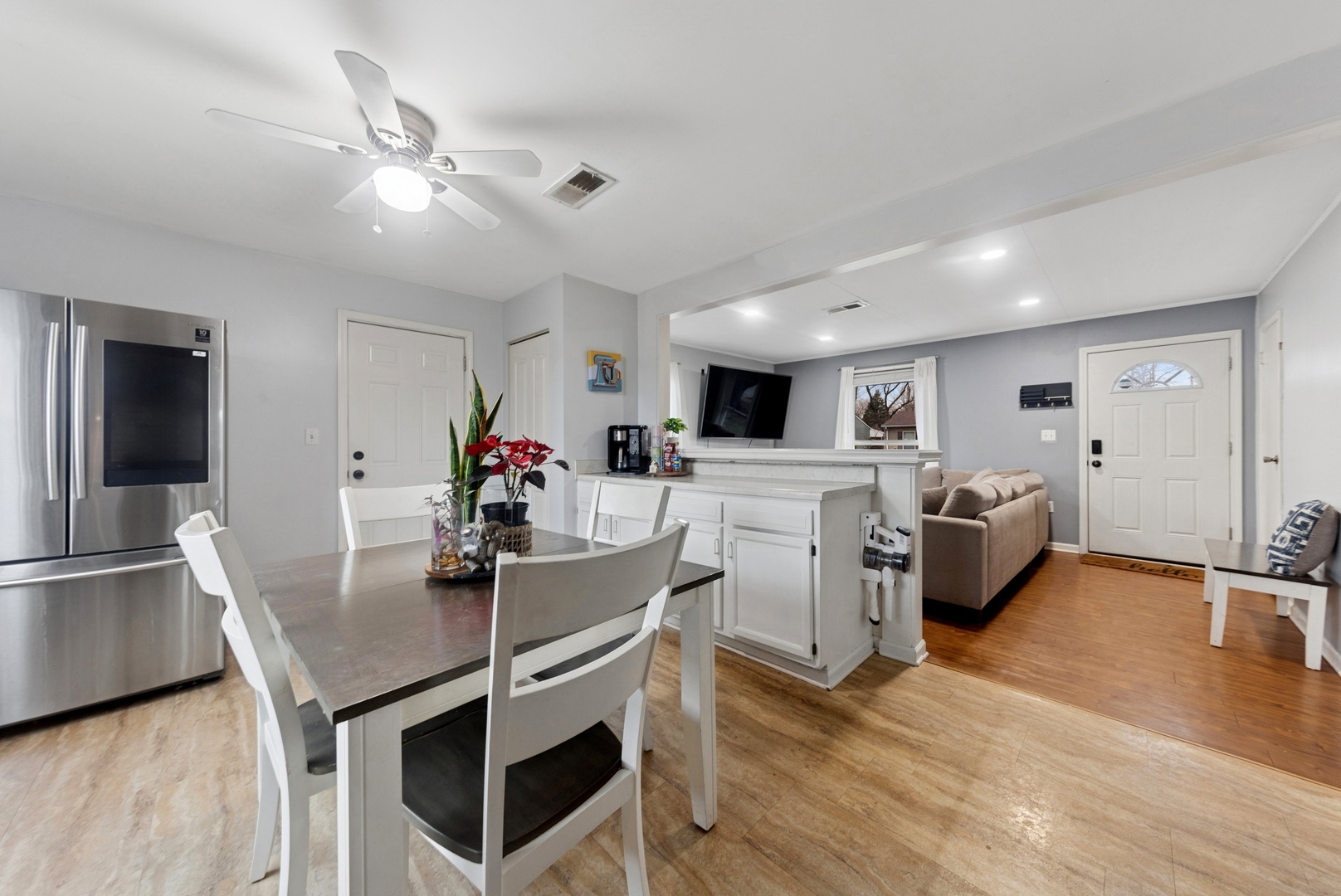 335 Macon Avenue Romeoville, IL 60446 - Photo 7 of 19 a kitchen with white cabinets and stainless steel appliances