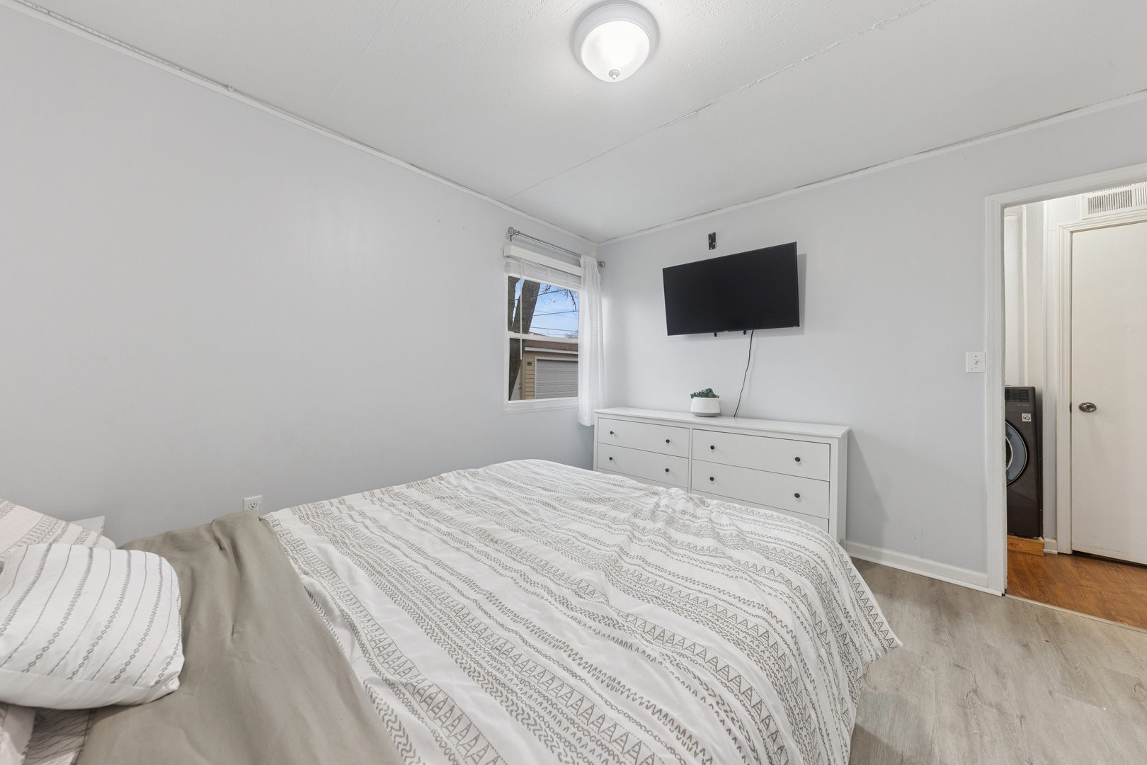 335 Macon Avenue Romeoville, IL 60446 - Photo 10 of 19 a bedroom with a bed and a flat screen tv