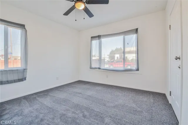 an empty room with windows and closet