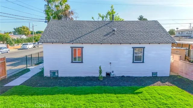 a view of a house with a yard and pathway