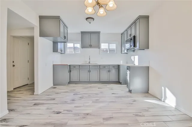 a view of a kitchen with microwave and cabinets