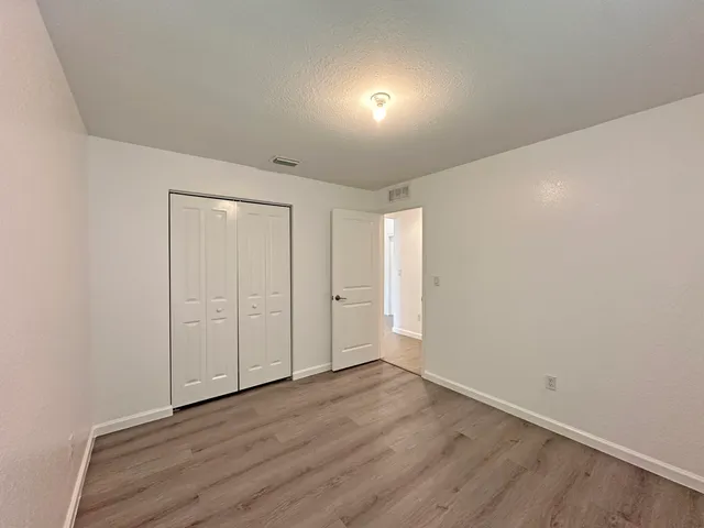 a view of an empty room and wooden floor