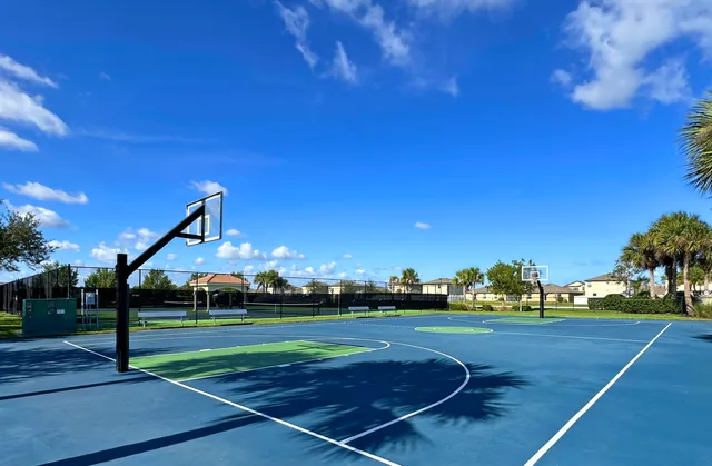 a view of an outdoor space and basketball court