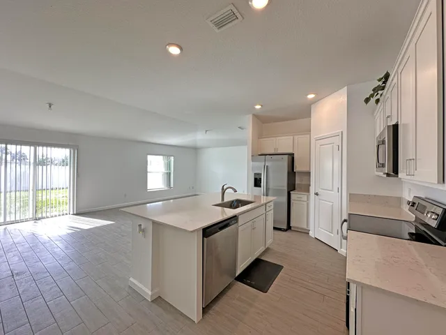 a kitchen with a sink stove and refrigerator