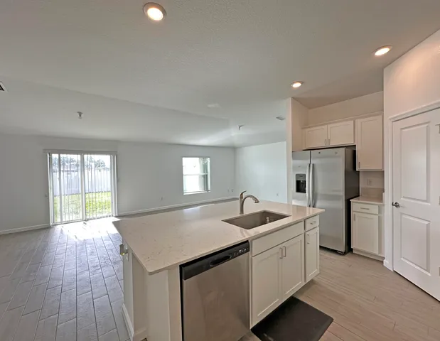 a kitchen with a sink stove and refrigerator