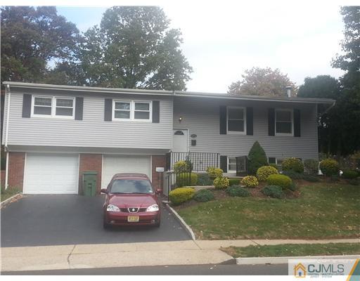 46 Harmon Road Edison, NJ 08837 - Photo 1 of 17 a front view of a house with garden