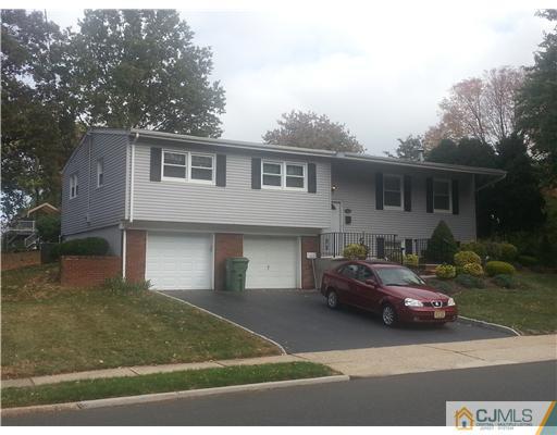 46 Harmon Road Edison, NJ 08837 - Photo 2 of 17 a front view of a house with a garden