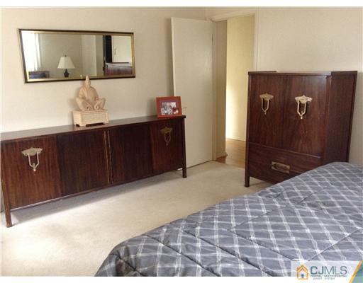 46 Harmon Road Edison, NJ 08837 - Photo 11 of 17 a bedroom with a bed and painting on the wall