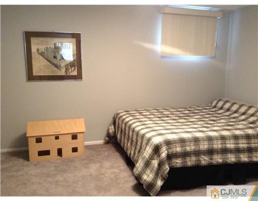 46 Harmon Road Edison, NJ 08837 - Photo 12 of 17 a bedroom with a bed and a window