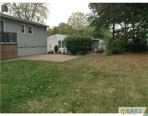 46 Harmon Road Edison, NJ 08837 - Photo 15 of 17 a view of a backyard with large trees