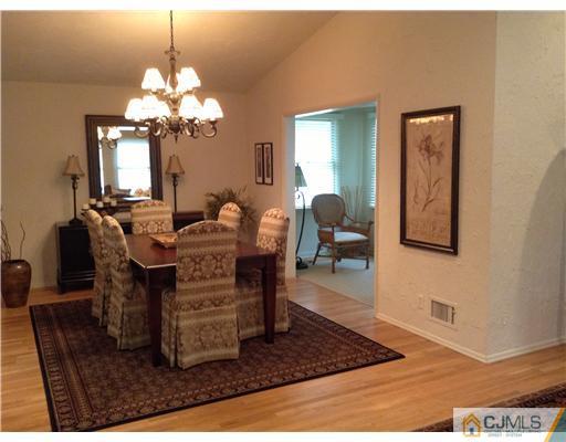 46 Harmon Road Edison, NJ 08837 - Photo 7 of 17 a dining room with chandelier and wooden floor