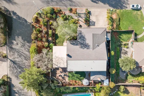 a view of a patio with table and chairs and potted plants