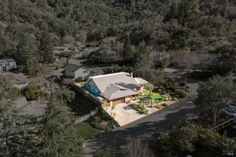 a living room with furniture a fireplace and a large window