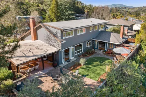 a view of a dining room with furniture a chandelier and wooden floor