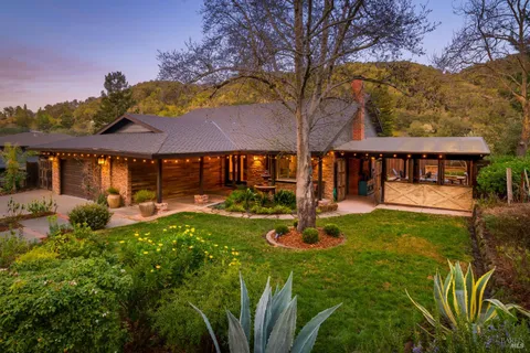 a view of an house with backyard space and sitting area