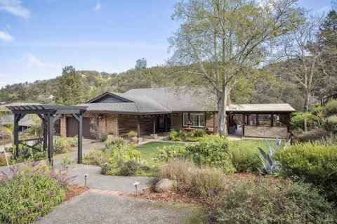 a lamp on a table in front of a house