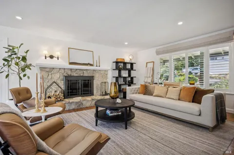 a view of a kitchen with kitchen island granite countertop a large window and stainless steel appliances