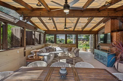 a bathroom with a granite countertop sink a mirror a vanity and shower