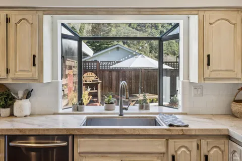 a view of a patio with table and chairs under an umbrella