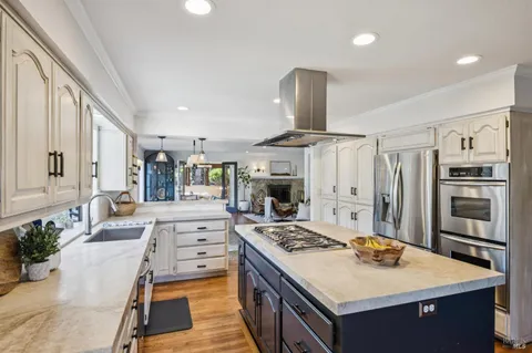 a view of backyard with barbeque grill and outdoor seating