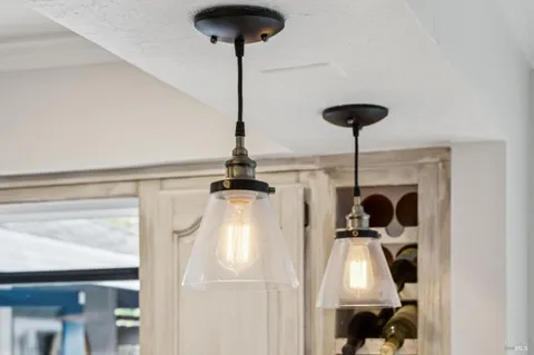 a patio with a table and chairs and potted plants