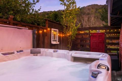 an aerial view of a house with garden space and street view