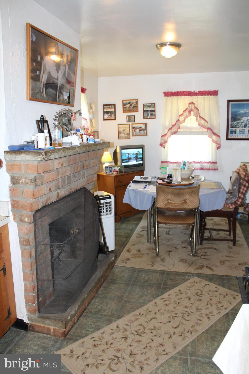 3359 Poplar Run Road Manchester, MD 21102 - Photo 6 of 30 a living room with furniture a flat screen tv and a fireplace