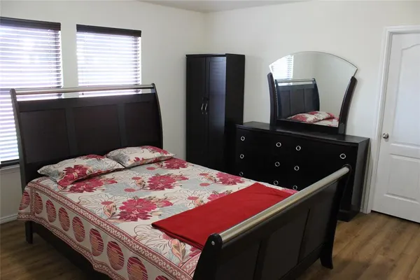 a bed room with a bed and a television