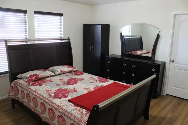 a bed room with a bed and a television