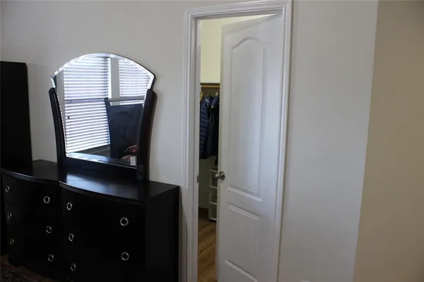 a view of hall way with mirror and window