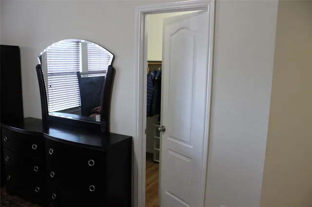 a view of hall way with mirror and window