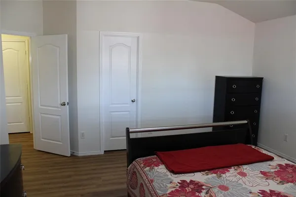 a bedroom with a bed and a dresser