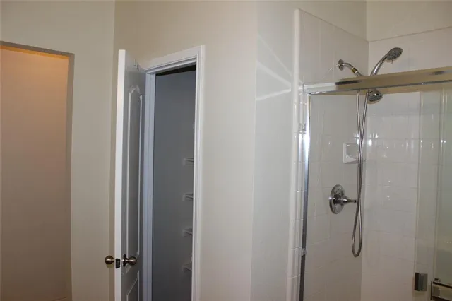 a bathroom with a glass shower door