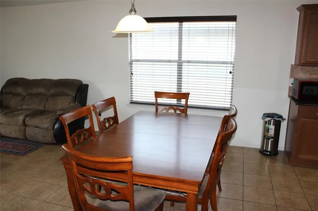 a view of a dining room with furniture and a window